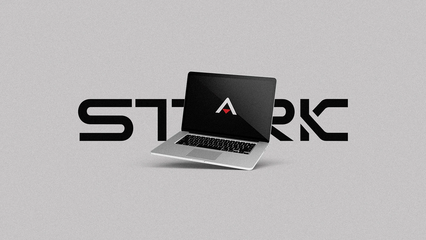 Identidade da Agência Stark aplicada em um notebook, com logotipo preto e detalhes vermelhos